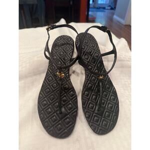 Tory Burch black sandals with gold accents.